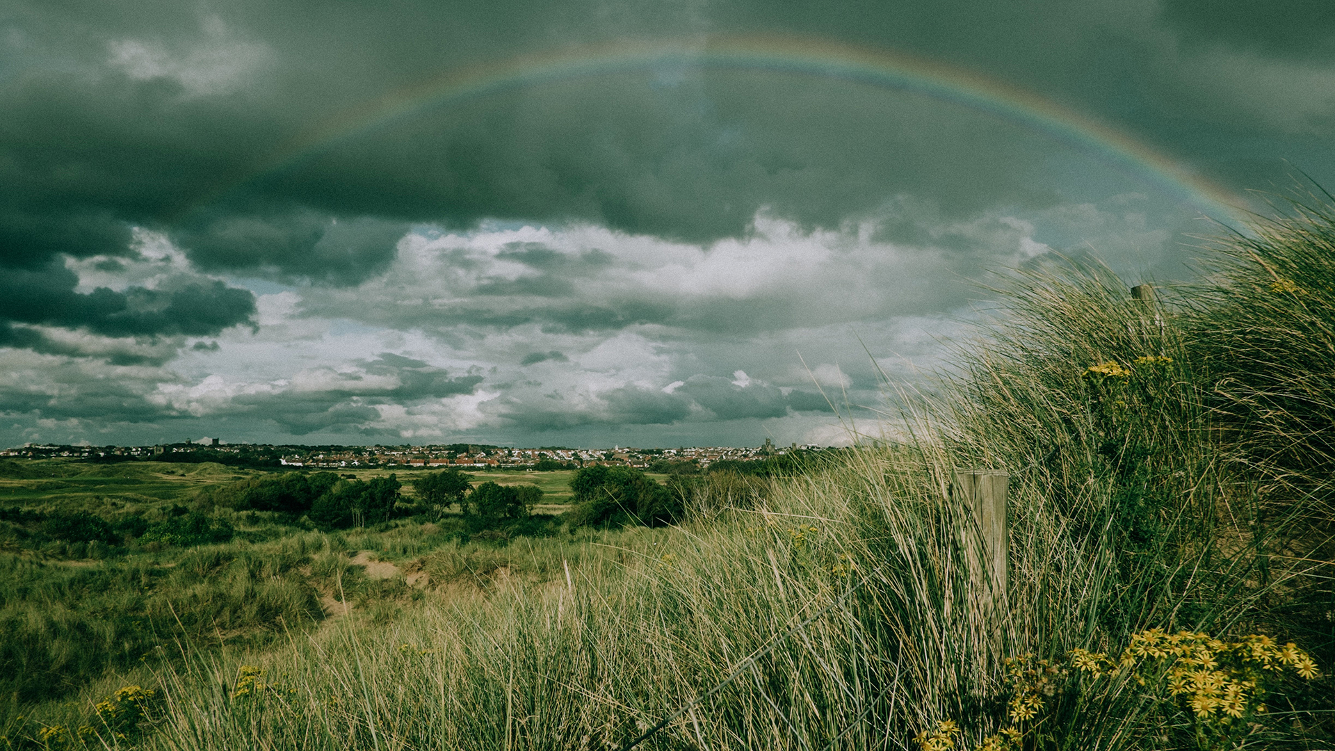 Overcast skies with a rainbow.